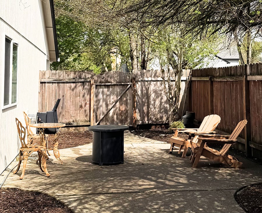 The private, fully fenced backyard with seating, BBQ, picnic table and gas fire pit is ideal for quiet mornings or relaxed evenings.