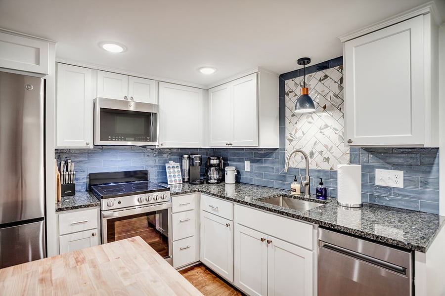 The kitchen is fully stocked and equipped by someone who loves to bake and cook. A variety of pots and pans, bakeware, utensils, small appliances, and food storage items are provided.