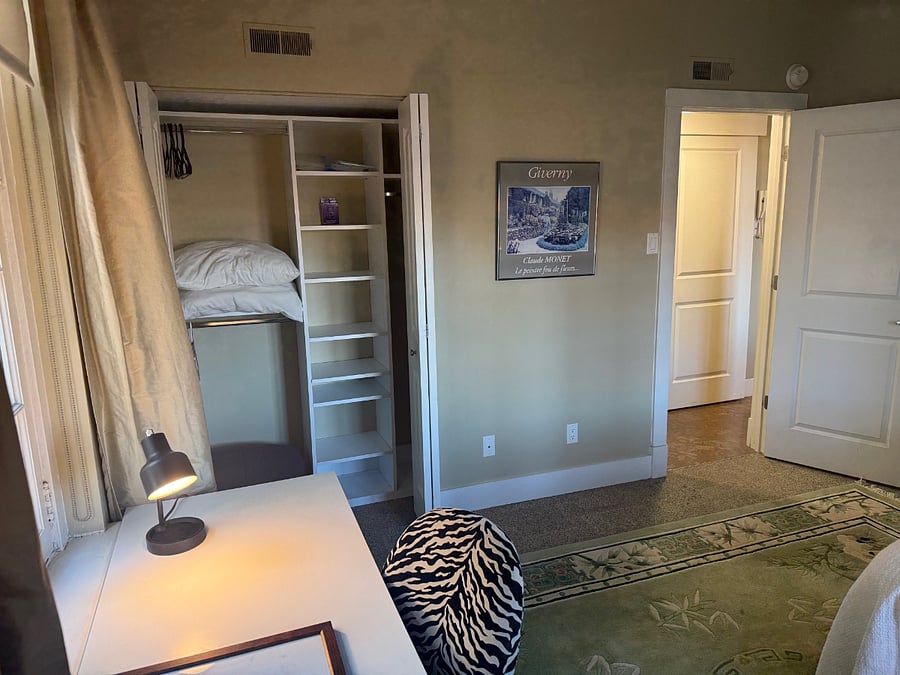 Part of bedroom area, desk & bedroom closet