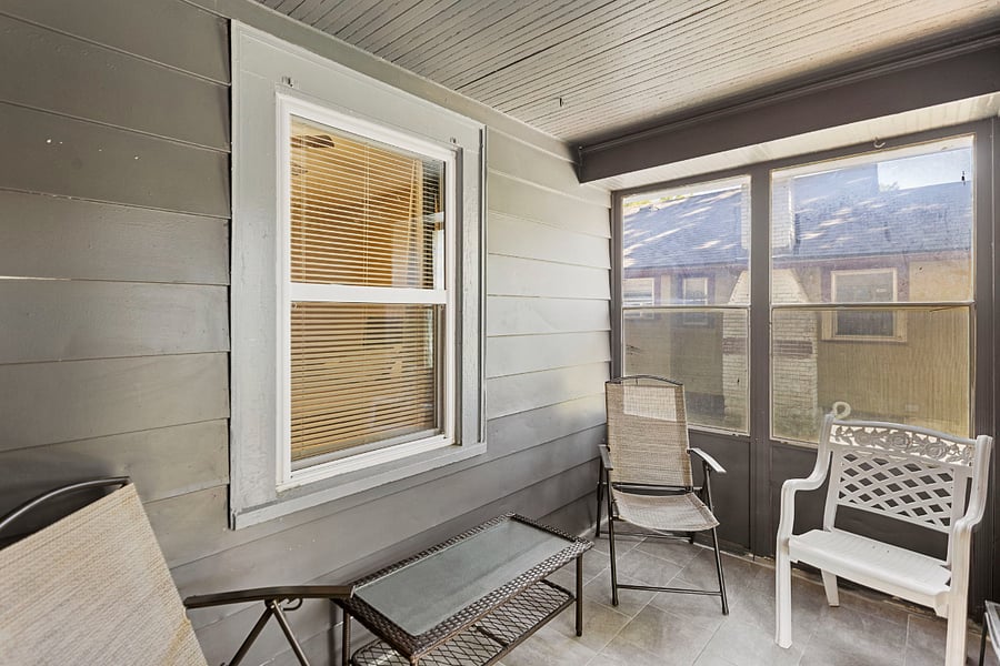 Enclosed front porch with seating a great space to relax or enjoy morning coffee