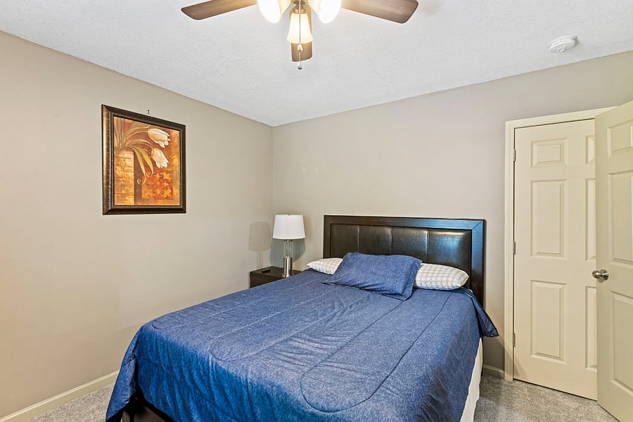 Primary bedroom with comfortable bed and ample storage