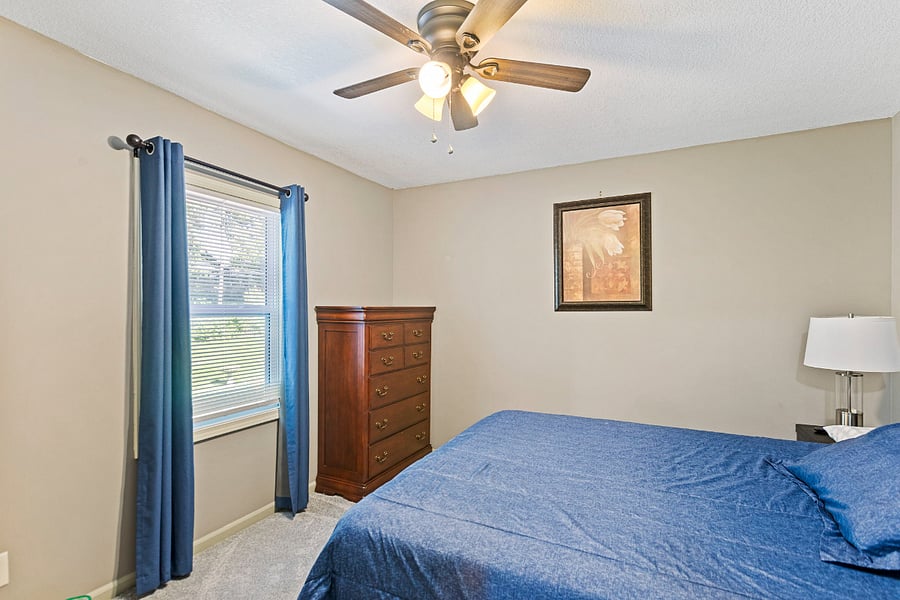Primary bedroom with comfortable bed and ample storage