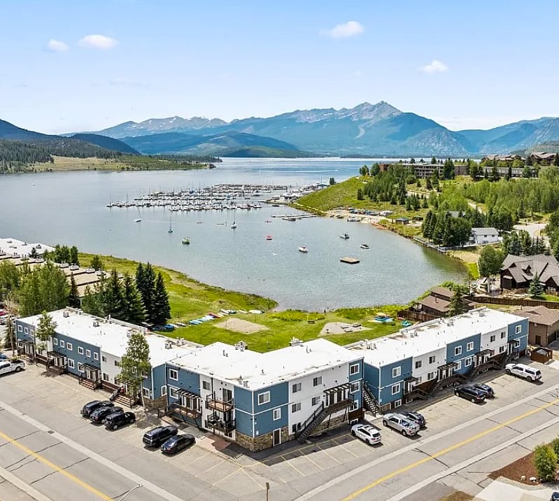 View of condo complex overlooking the private lawn, Lake Dillon, Dillon Marina, and the Ten Mile Range.