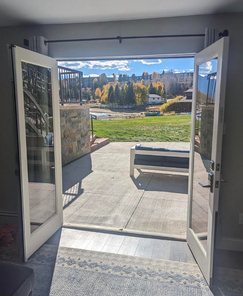View from the living room out onto the patio and condo complex's private lawn.