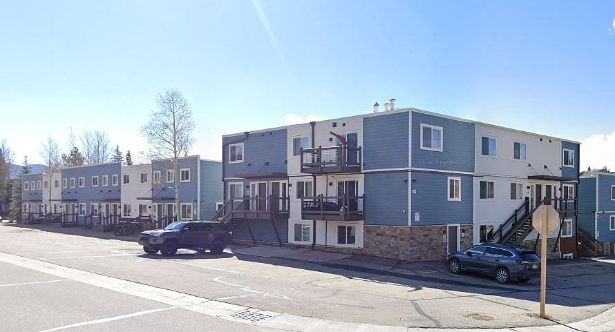 Exterior of condo complex from parking lot. 