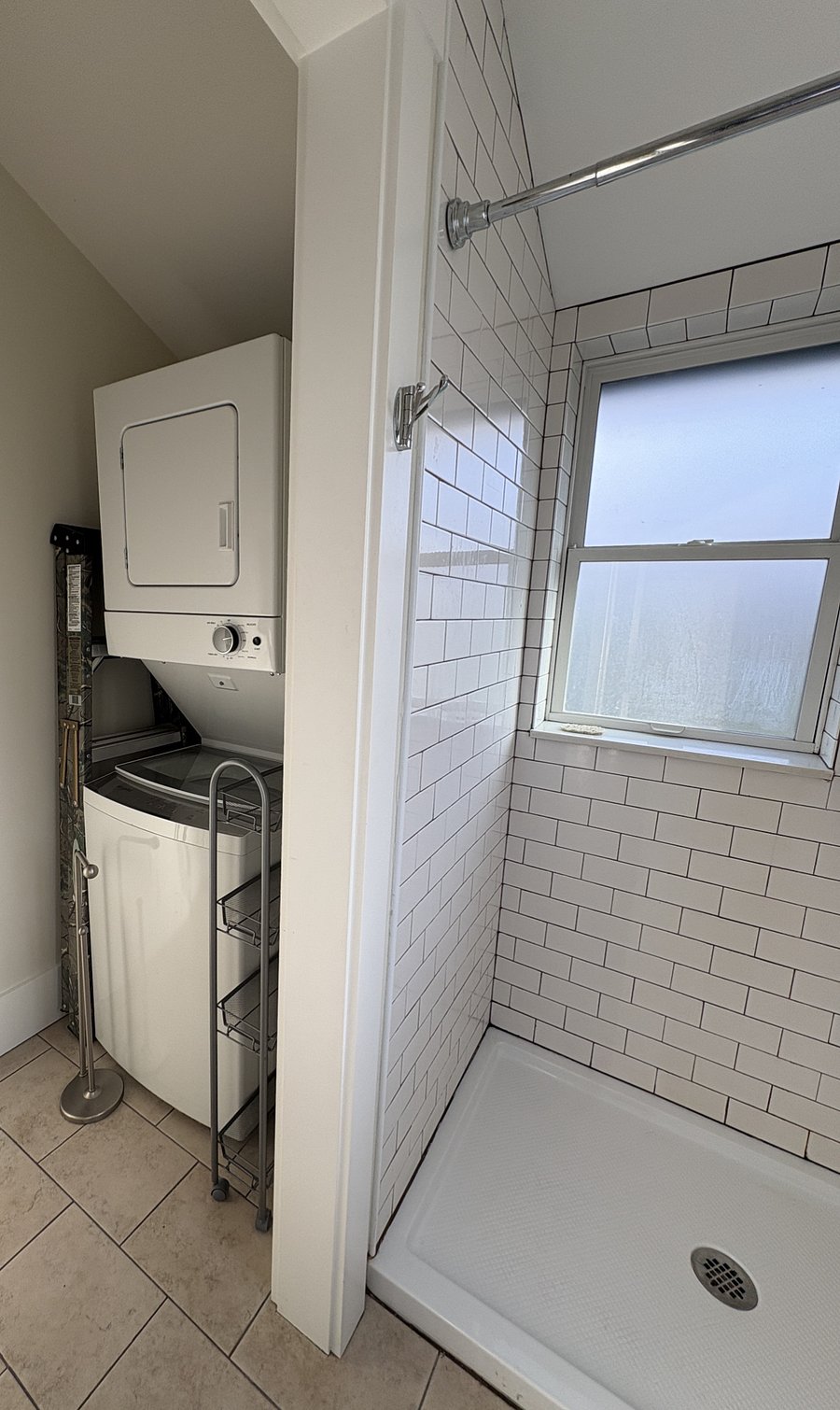 View into wash/dryer area with more storage