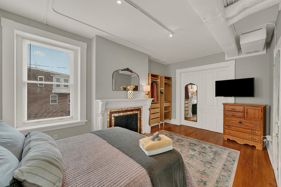 Very comfy bedroom with queen bed, plush rug and French doors. (fireplace is decorative only)
