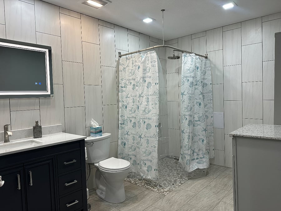 large bathroom, with roll-in shower, heated and lighted mirror.