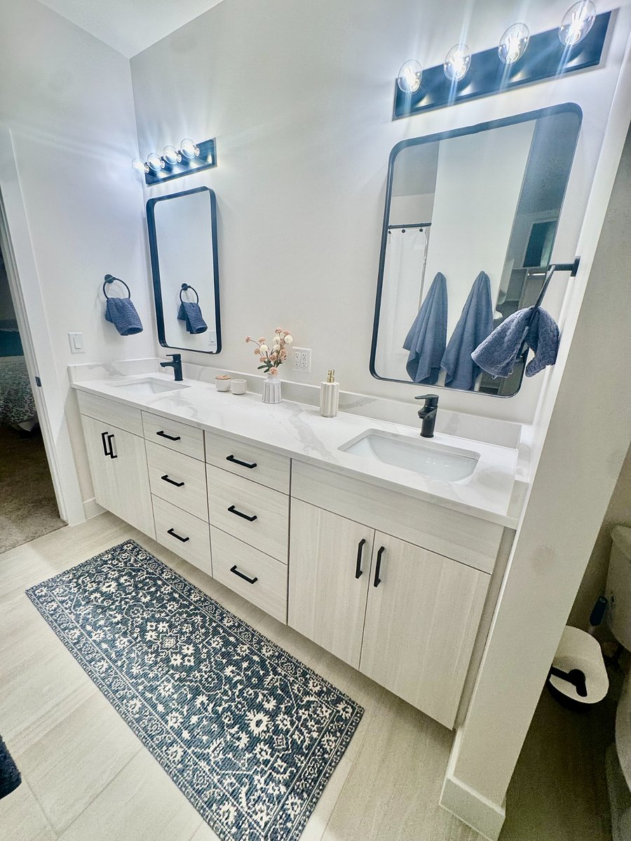 Master bathroom with double sinks and shower