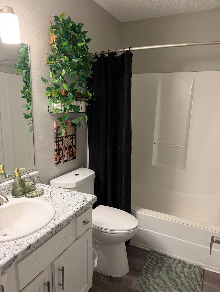 Bathroom w/ bathtub/shower&toilet. Both bathrooms have been upgraded with a handheld shower head in addition to the standard attached to the wall.