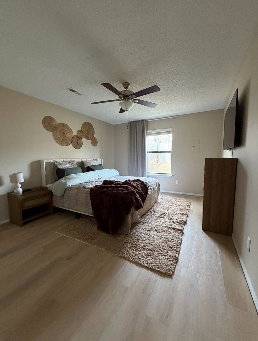 Master bedroom w/King size bed and nightstands w/powerstations. Spacious room w window to private backyard