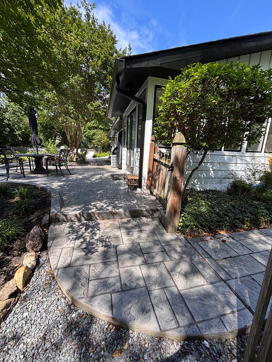 This photo shows the one step up to the paved patio from the driveway sidewalk entrance. This is egress area only to access the unit door entrance. The furniture and area pictures is not available for use by the occupant.