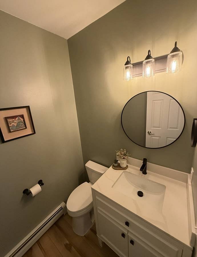 half bath, recently updated- new floor, paint, sink, vanity, and mirror