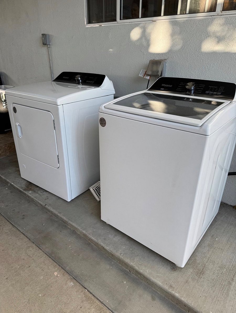 Communal washer and dryer in the backyard. 
