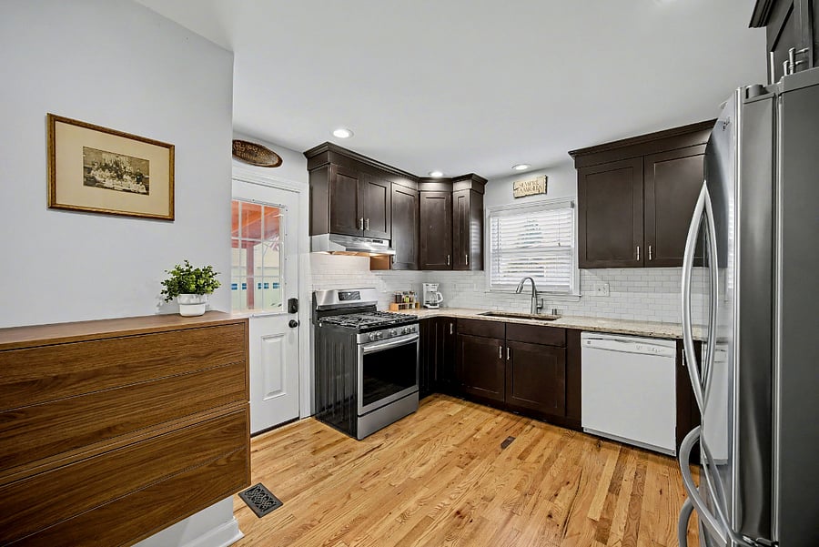Kitchen with door to fenced-in backyard