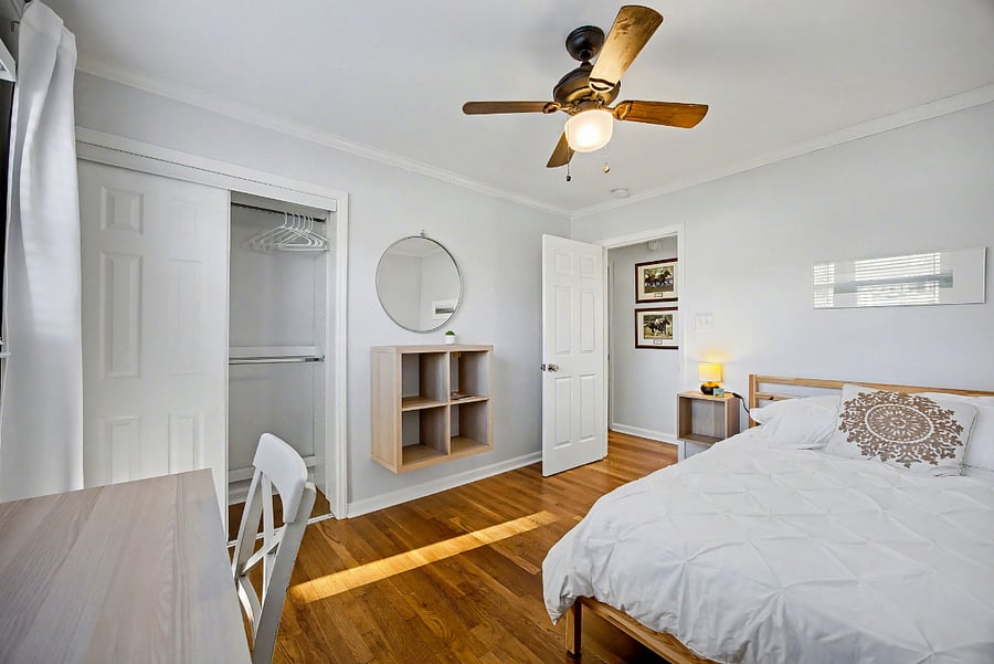 Bedroom #1 with full size bed, designated work space & custom built closet