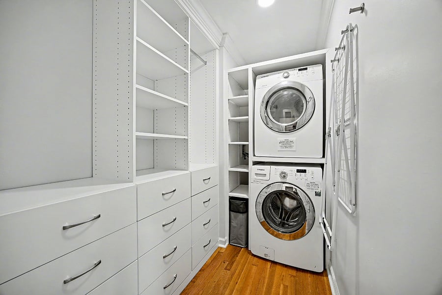 Laundry area with custom built-in closet, hooks & drying rack for clothes