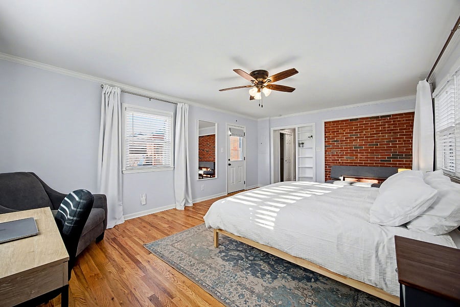 Bedroom #3 with king size bed, designated work space & door to fenced in backyard