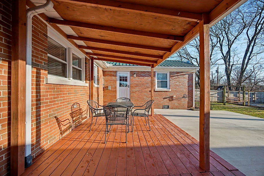 Covered back deck with exterior doors to kitchen & bedroom #3