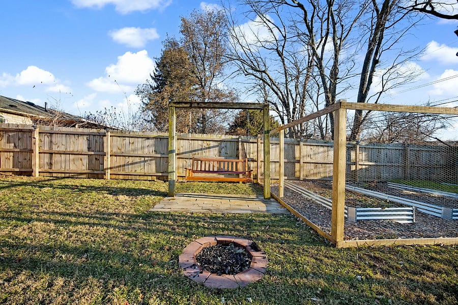 Fenced-in backyard with outdoor swing