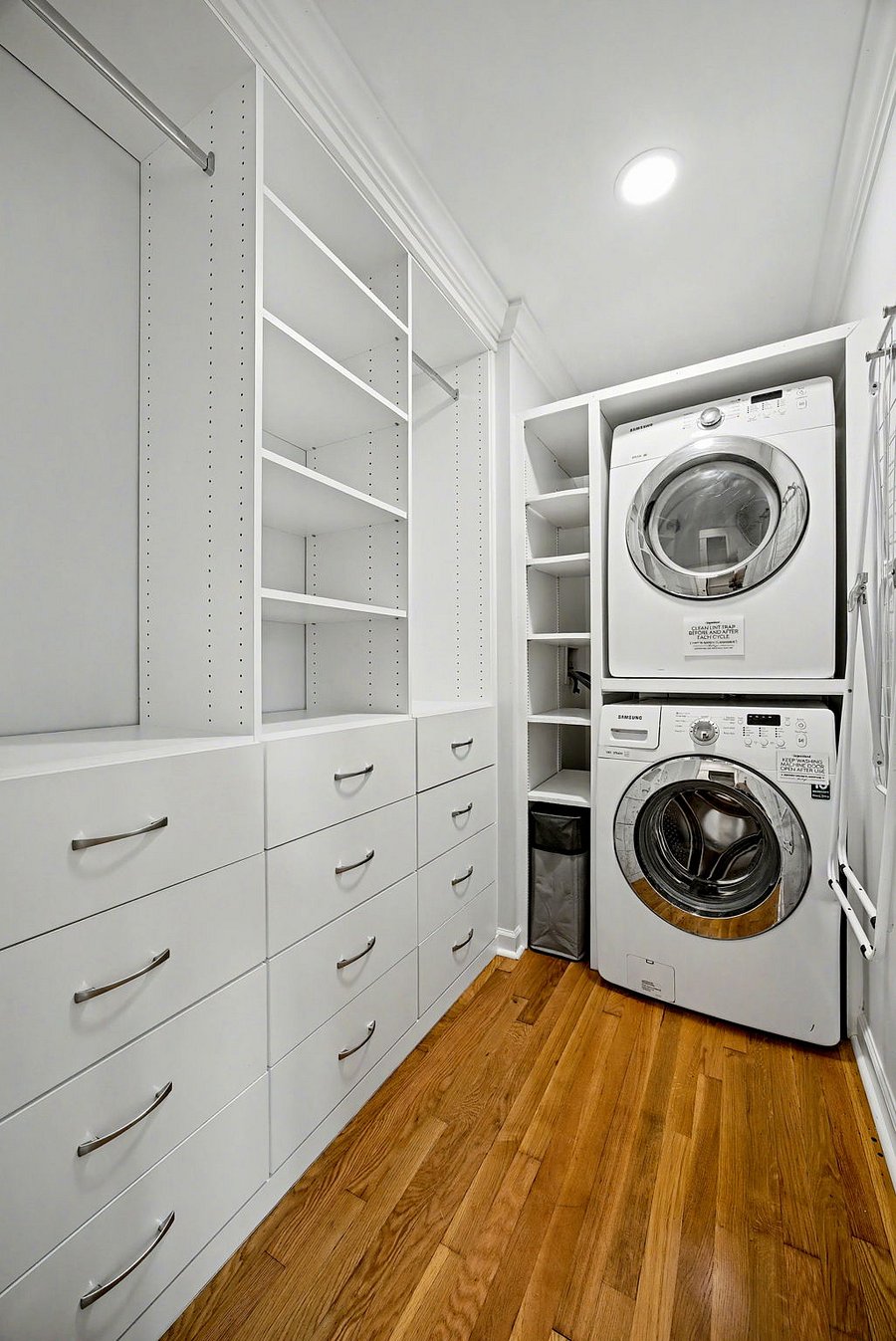 Laundry area with custom built-in closet, hooks & drying rack for clothes