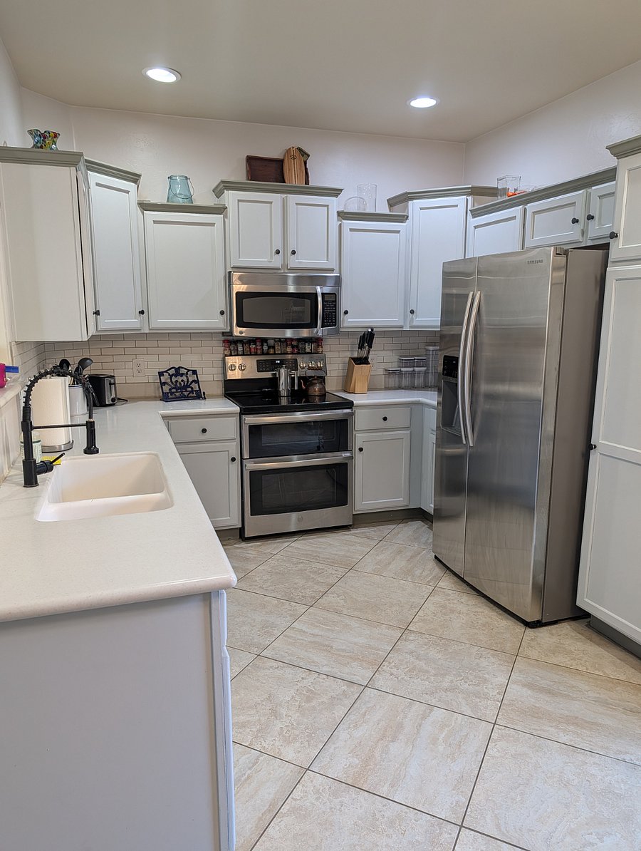 A modern take on how good grandma's house smelled with tiled floors, stainless steel appliances, and double oven.