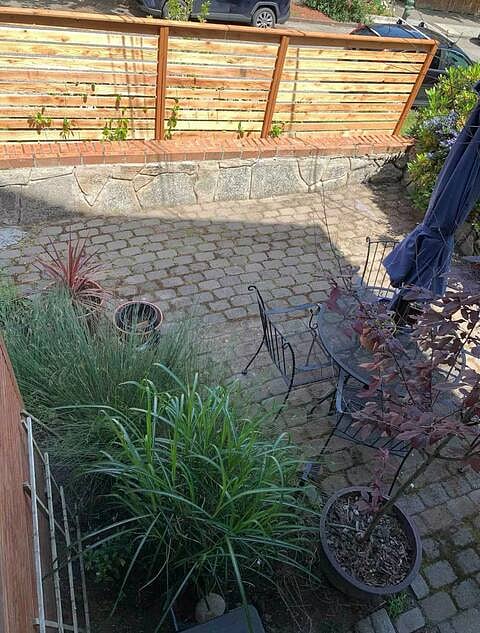 Outdoor patio area with umbrella, table and chairs