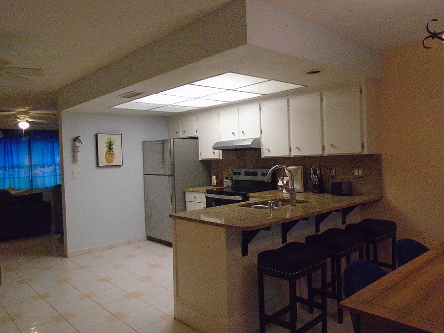Spacious kitchen, new dishwasher, plates, silverware, glasses