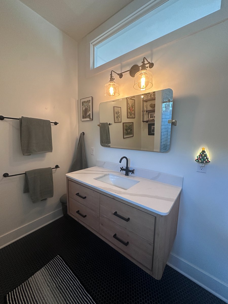 Spa-like bathroom with a huge walk-in shower and endless on-demand hot wateryoull never run out. Enjoy the rain shower head with strong water pressure, a cozy built-in bench for relaxing with the handheld sprayer, and beautiful natural light from the valance window. Thoughtfully designed lighting by a local Portland-based School House company completes the space.