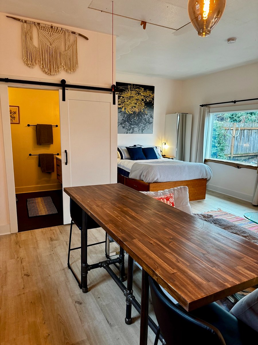 Sliding barn door opens to huge spa-like bathroom.  This shows the view from the bar counter work space in the kitchen.