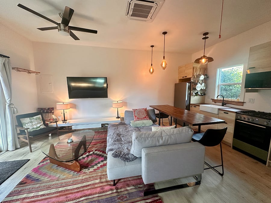 Super Cozy Open Concept Living Room to Kitchen with Bar/Counter Area.  Huge Jasmine plant with Hummingbirds flying around the Kitchen Window.