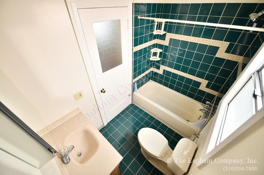Shared bathroom prior to move in. With soaking tub, mirrored vanity and window to the back garden.