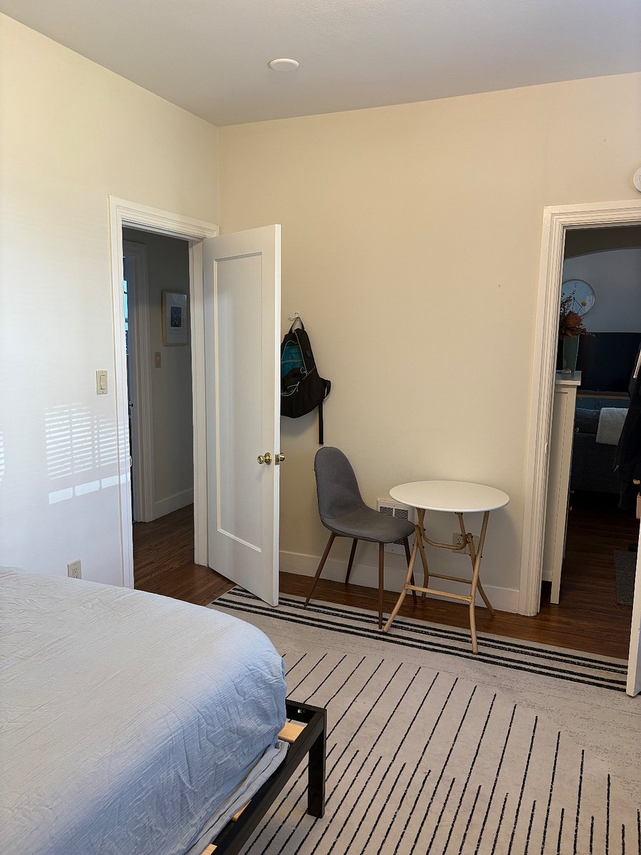 Shot of small table showing left door to hallway and right door to entrance way