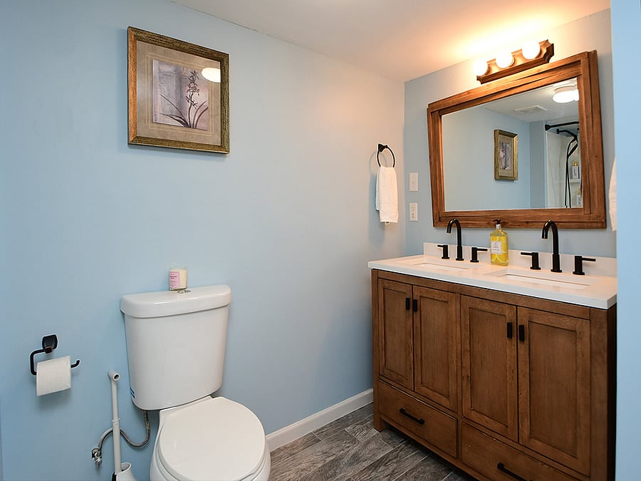 Main suite/lower lever bathroom # 1
Refresh in a beautifully updated bathroom with modern finishes and fixtures. It features a shower/tub combo with two sinks (his & hers) with fresh towels, essential toiletries and bright, clean space for comfort and convenience.