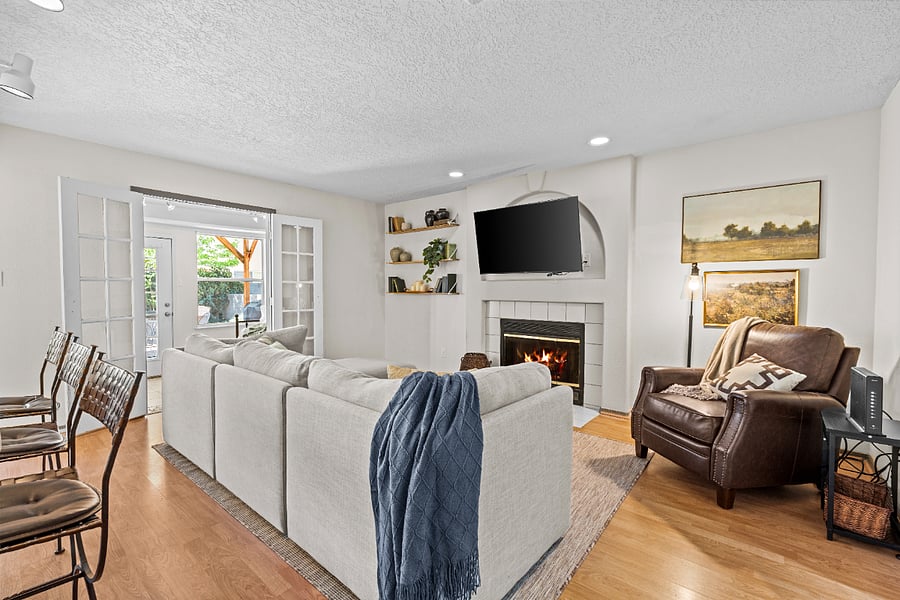 second living room right off of kitchen- features large smart tv, gas fireplace and large cozy sectional- perfect for gatherin