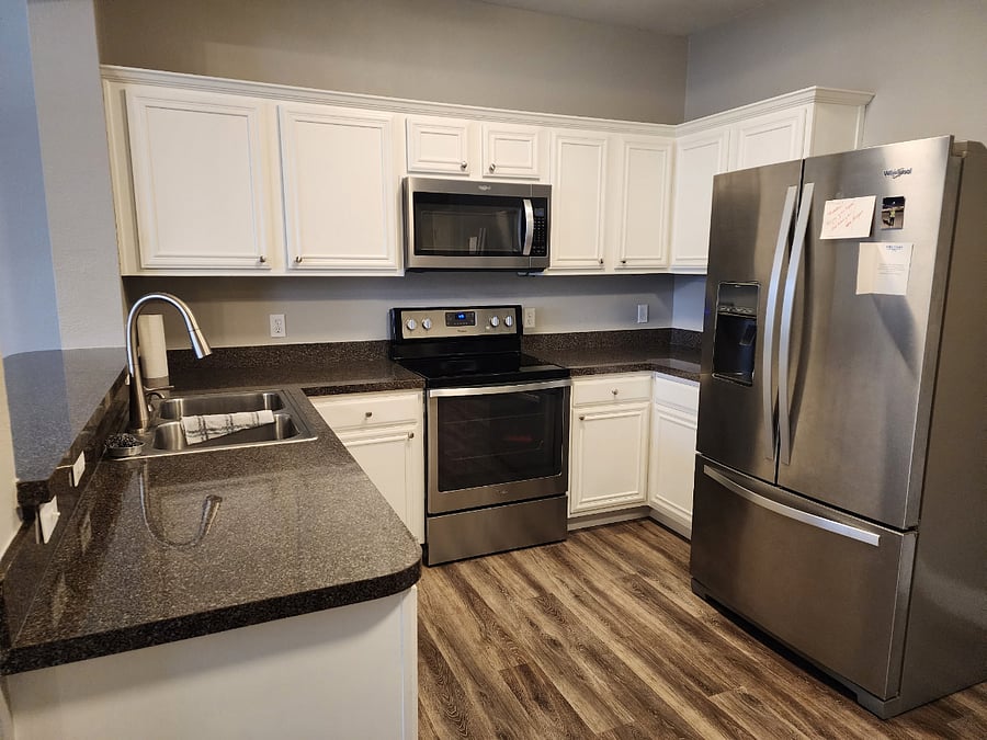 Newer stainless steel appliances in shared kitchen.