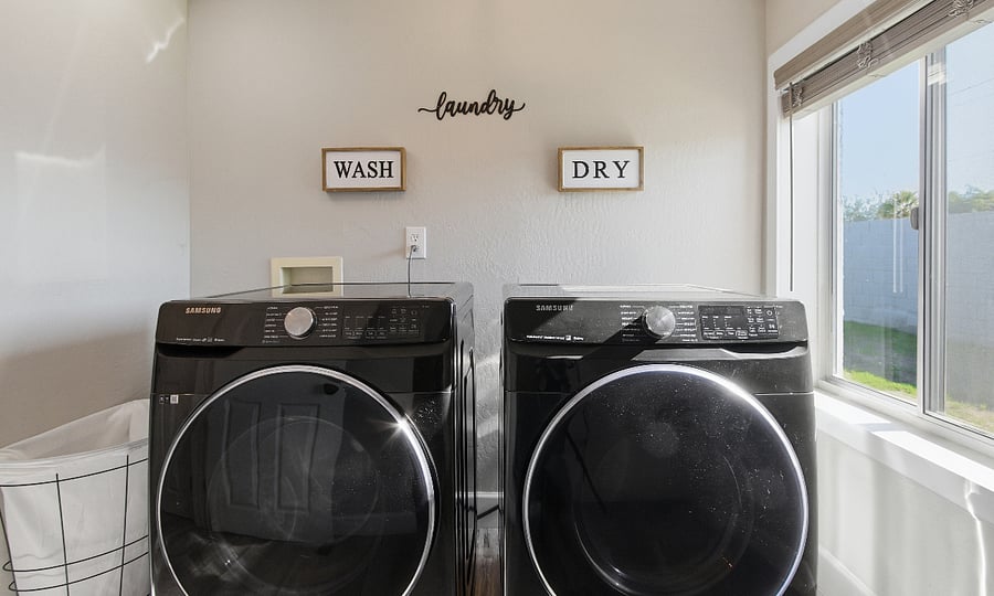 Full-service laundry room including brand new washer dryer.