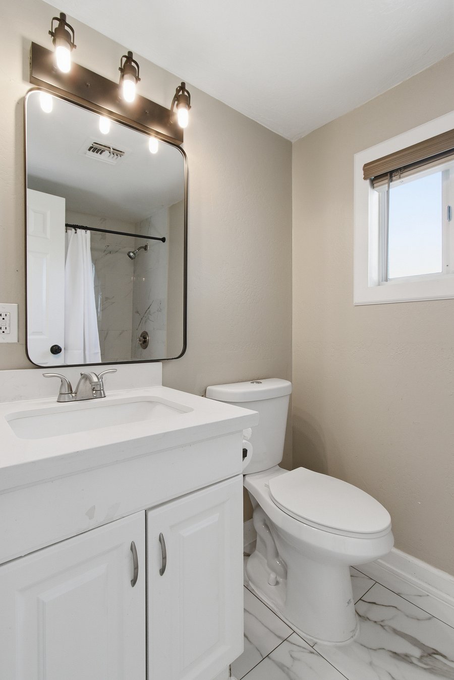 Bathroom #3 upgraded flooring and light fixtures, not pictured is a full-size shower and tub. All brand-new bed linens and towels provided.