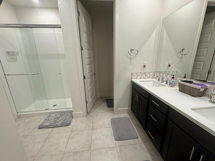 The primary en suite bathroom is super roomy with double vanity.