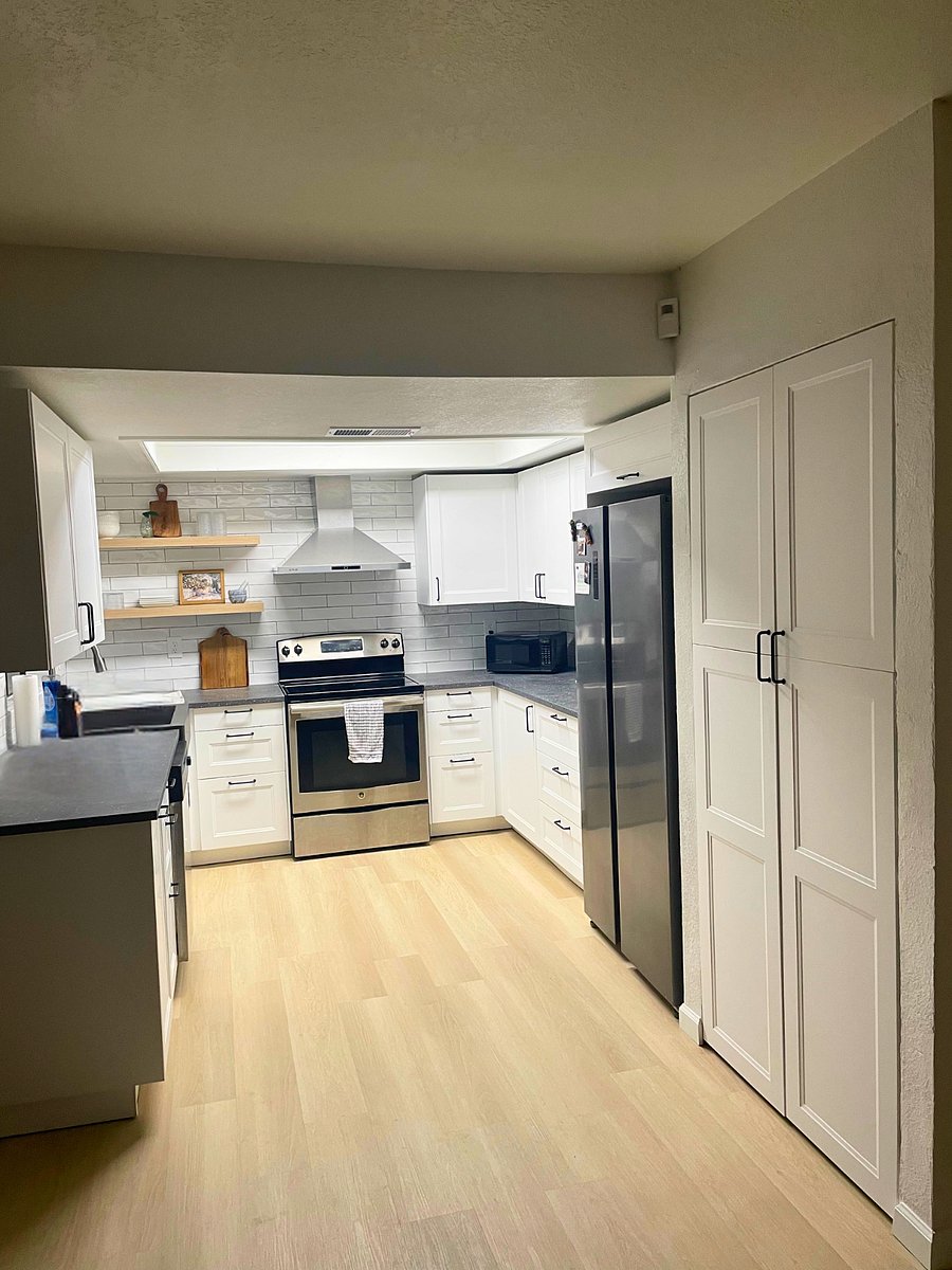 Completely remodeled kitchen includes new cabinets, counters, shelves, and exhaust fan