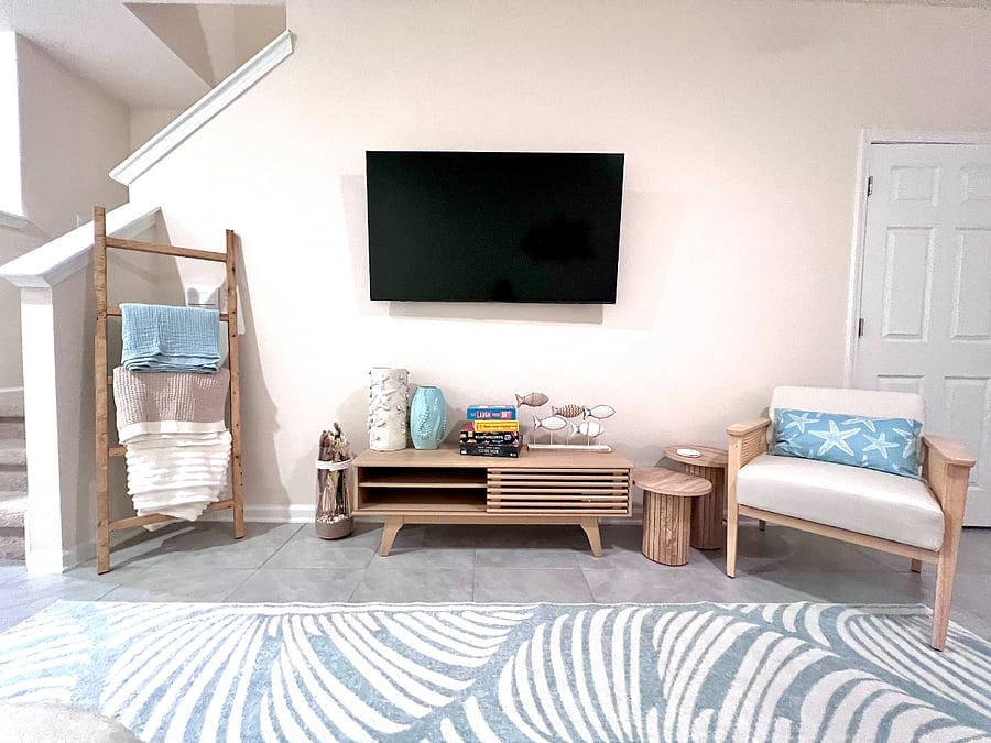 Living room with smart tv, board games, 1/2 bath, extra blankets.