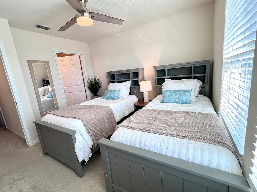 Bedroom 2 with a large closet, en suite bathroom, and ceiling fan