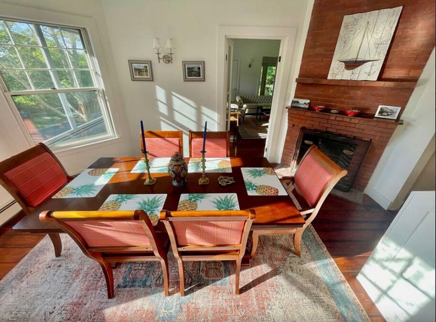 Dining room seats six with decorative fireplace