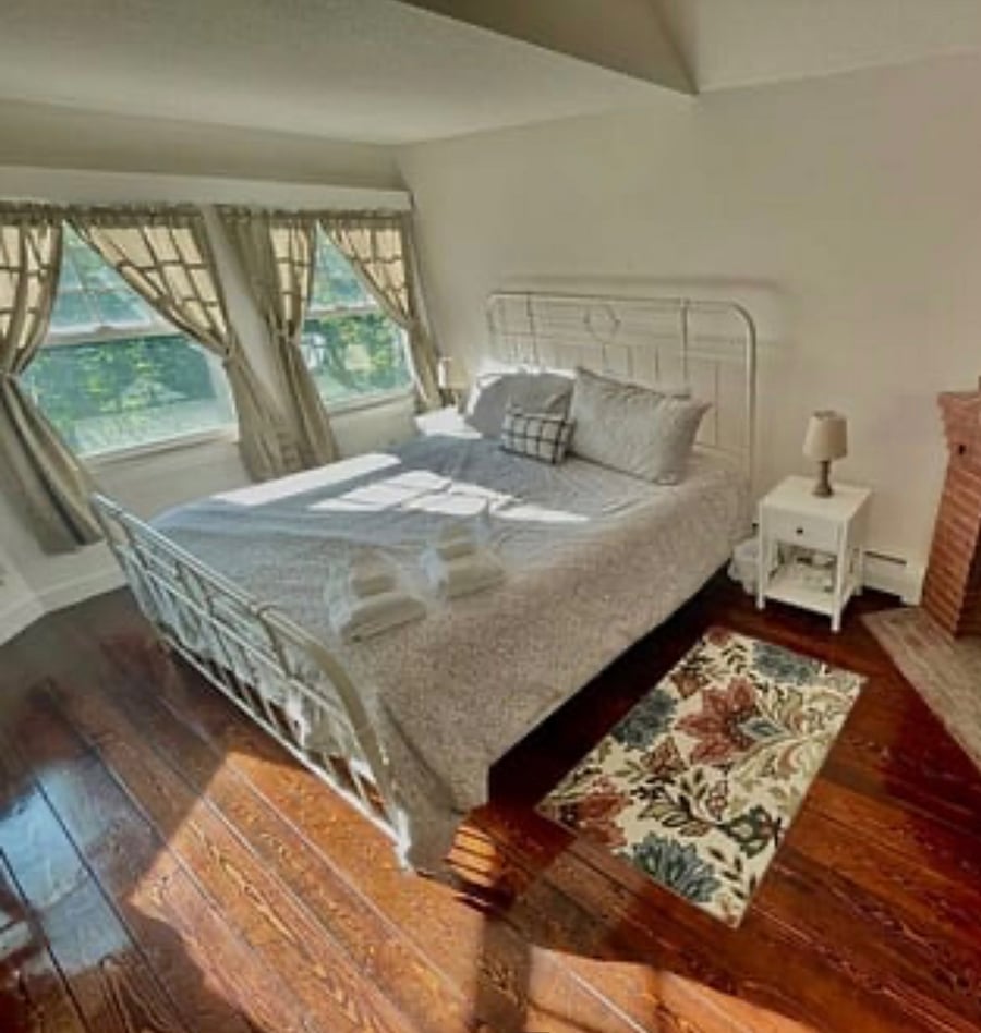 Master bedroom king bed with decorative fireplace place