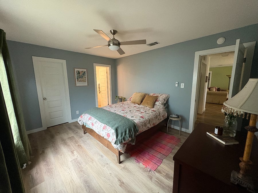 Queen-size bed, dresser and mirror to the side wall. Bedroom window looks out onto neighboring fence with jasmine vines growing up the side. Very private.
