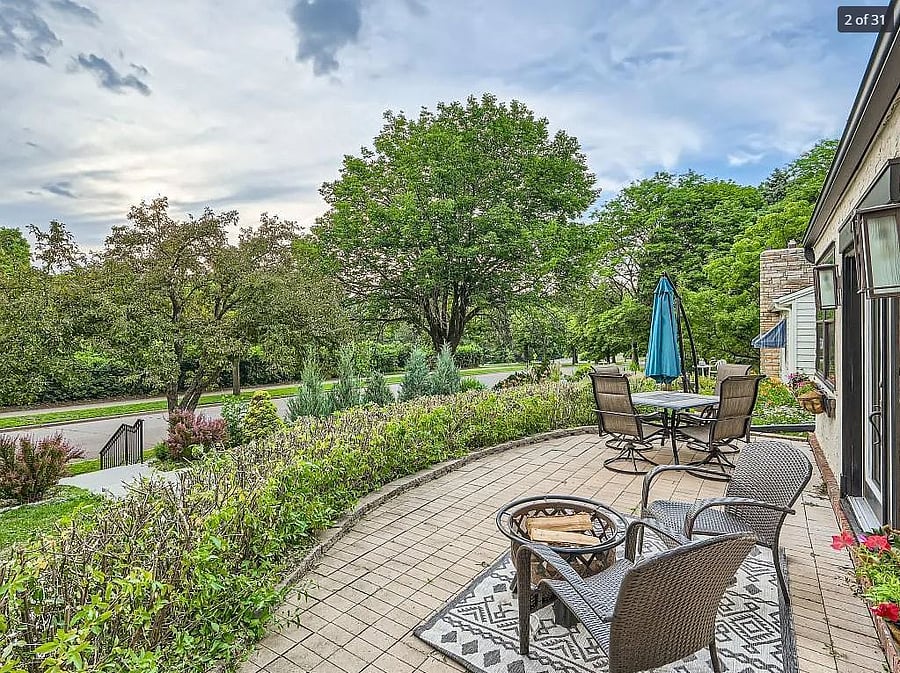 Front patio with French doors access to the main living room. The patio faces west for incredible sunsets and overlooks the edge of the park. 