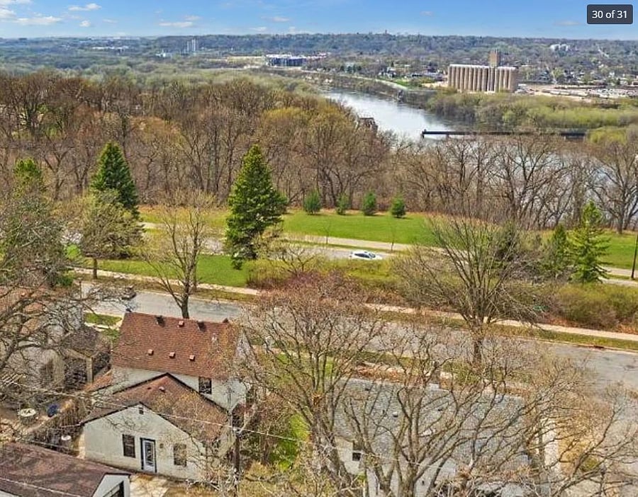The house overlooks walking trails, with the Mississippi river beyond, and skyline views of Minneapolis and Saint Paul.