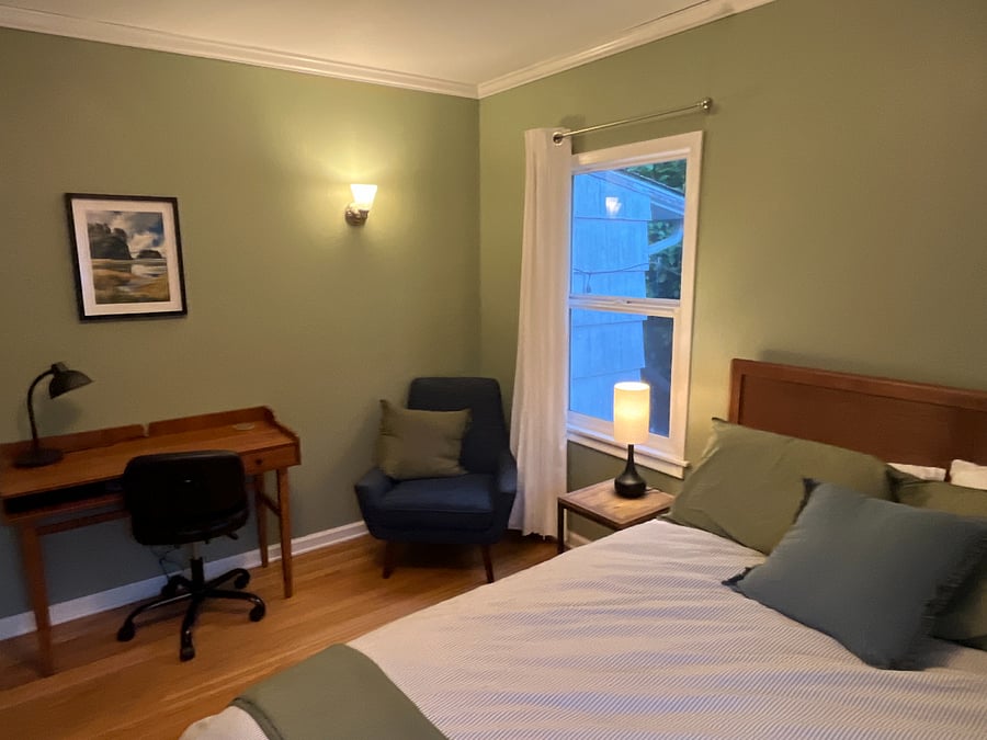 main bedroom with queen bed and desk
