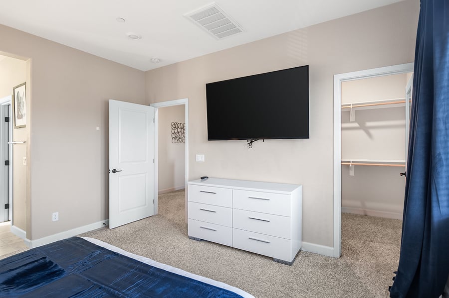 Spacious primary bedroom with king bed and blackout curtains