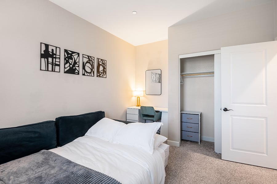 Multi-use room with queen sofa bed and workspace potential